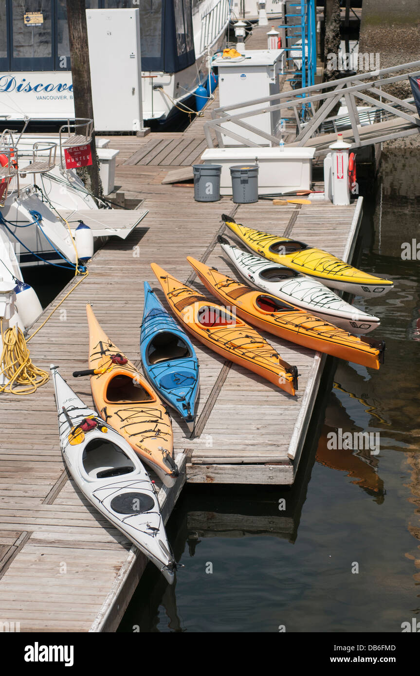Various colored kayaks on a dock on Granville island Vancouver BC Stock