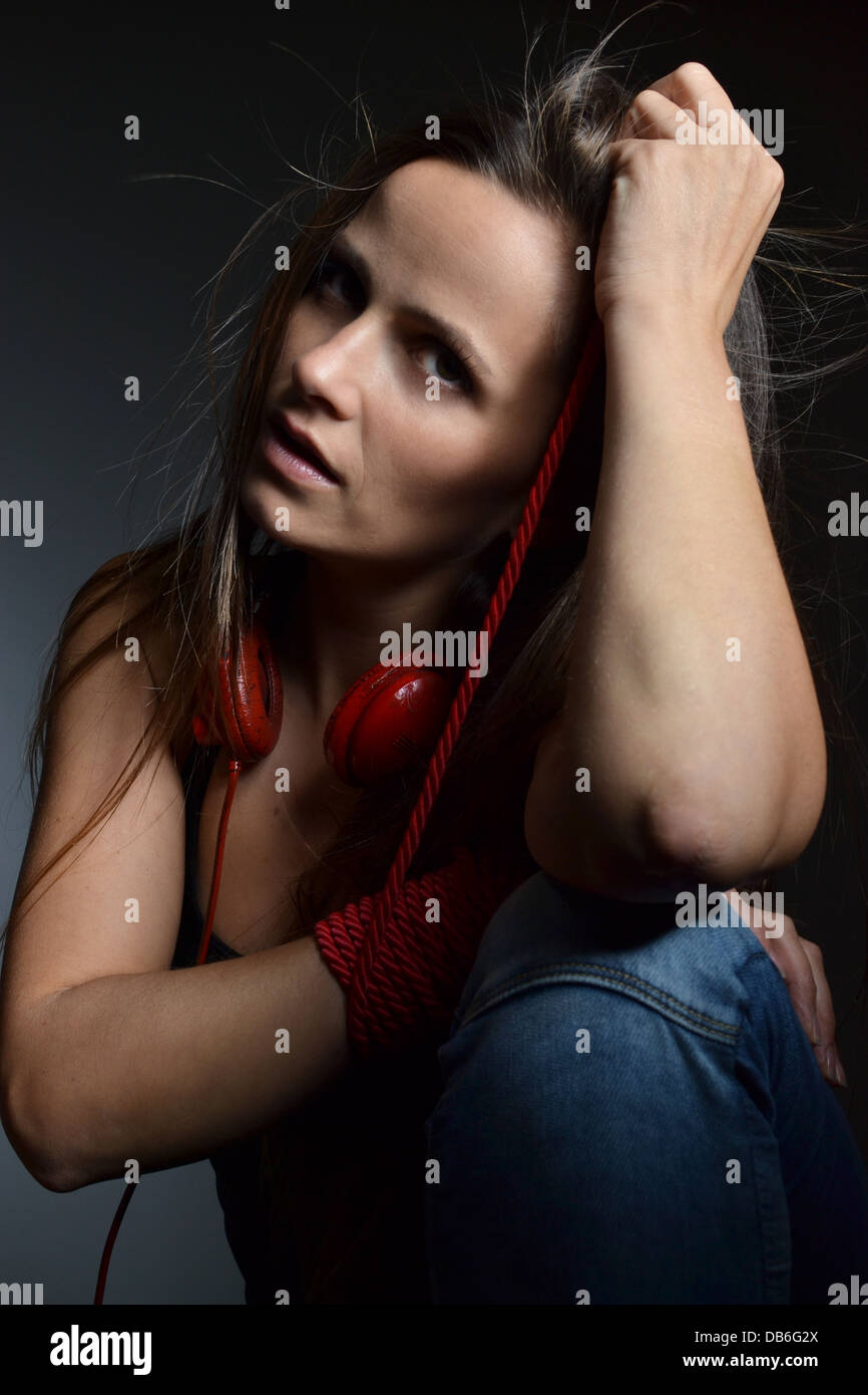 beautiful young woman tied with the red rope Stock Photo