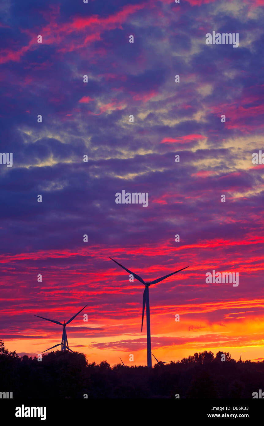 A silhouette of windturbines on a amazing sunset Stock Photo - Alamy