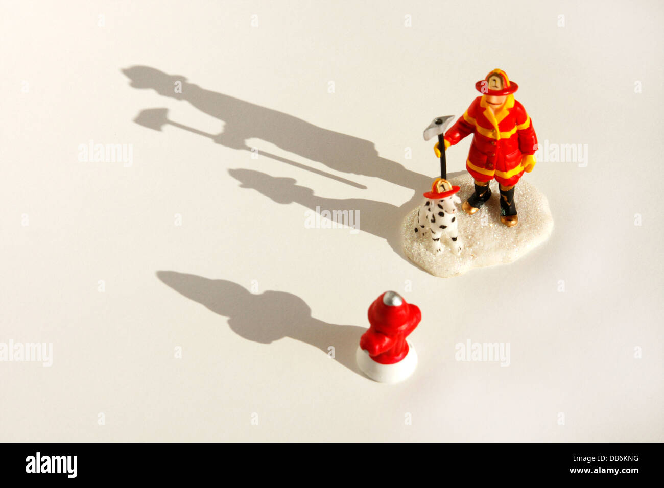 A fireman figurine with shadow. Focus on shadow Stock Photo