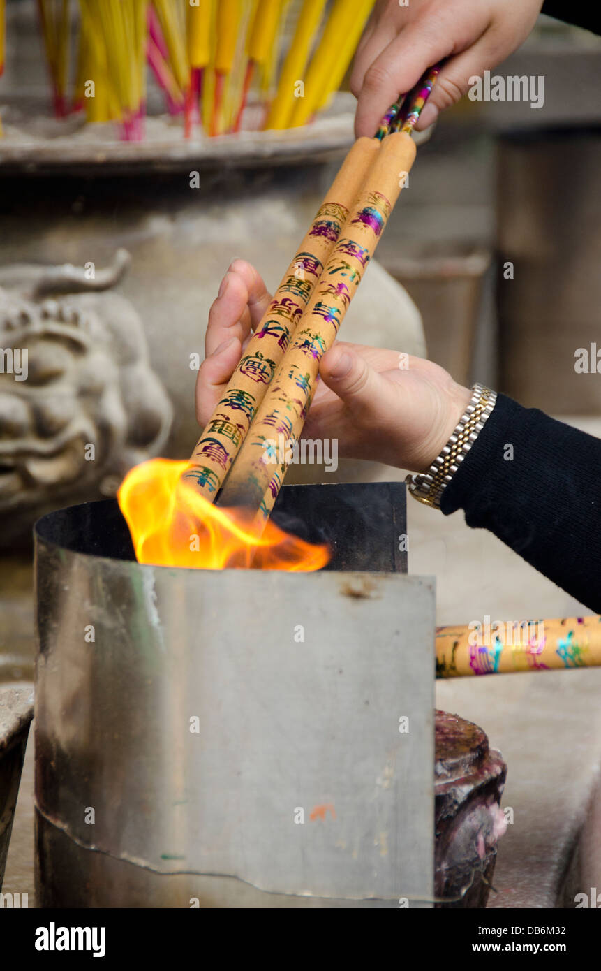 China, Macau. A-Ma Temple. Burning incense sticks and offering of ...