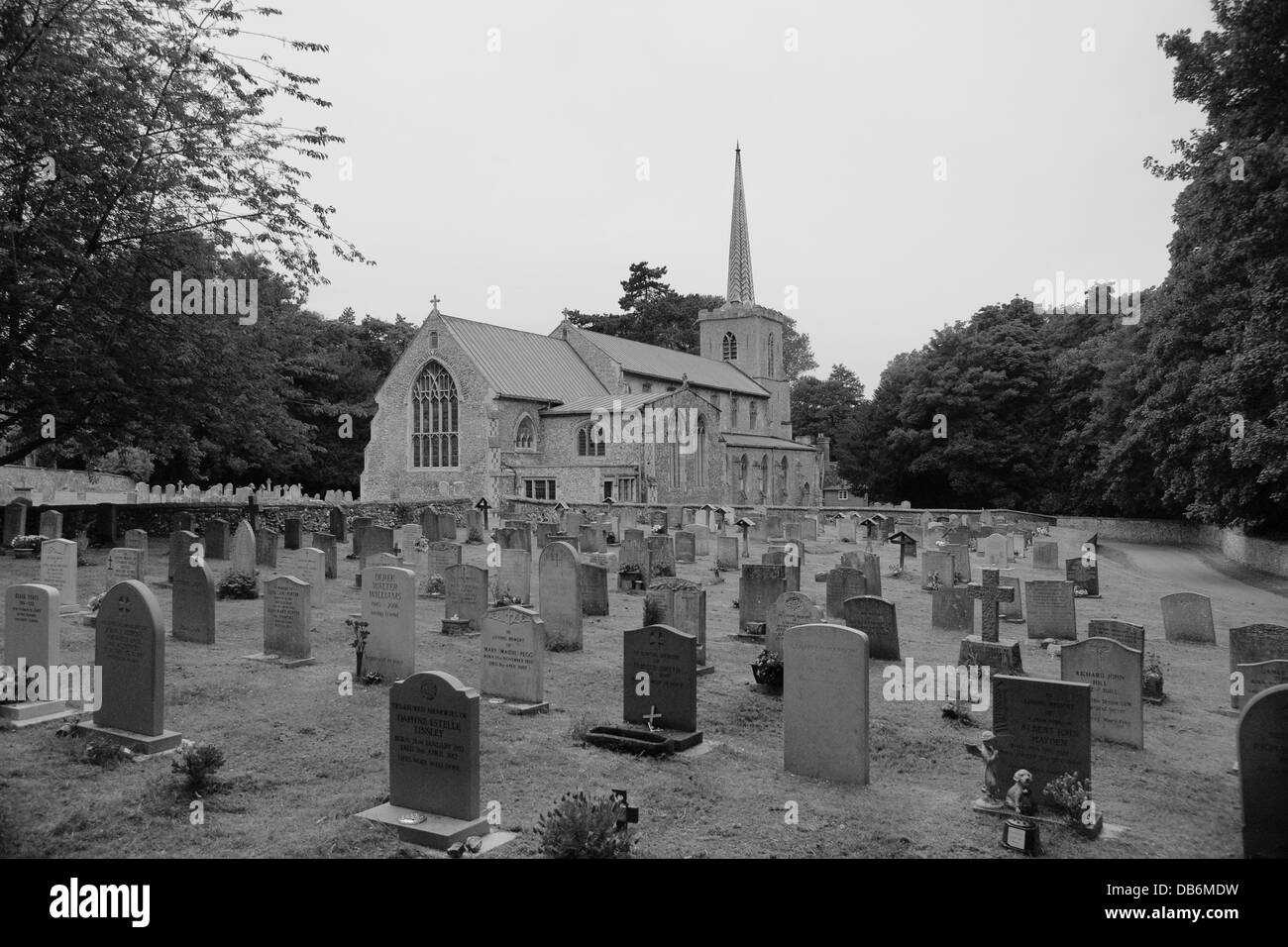 Black and White image of St. Marys Church and gravestone in Little Walsingham, Norfolk. Stock Photo