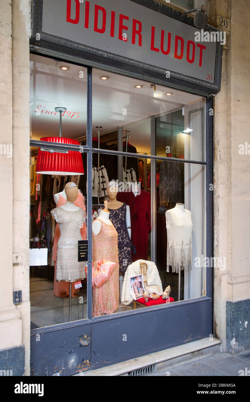 Colorful window display of vintage dresses at world-famous designer Didier Ludot's boutique at Palais Royal, Paris France Stock Photo