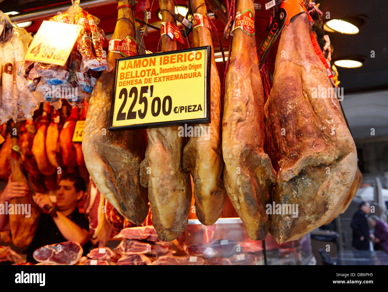 jamon iberico hams hanging inside the la boqueria market in Barcelona Catalonia Spain Stock Photo