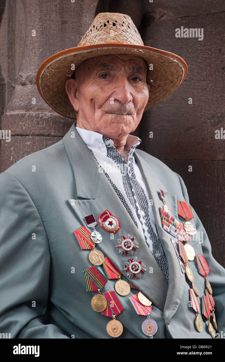 Decorated war veteran wearing his Soviet-era medals to church in Echmiadzin, Armenia Stock Photo