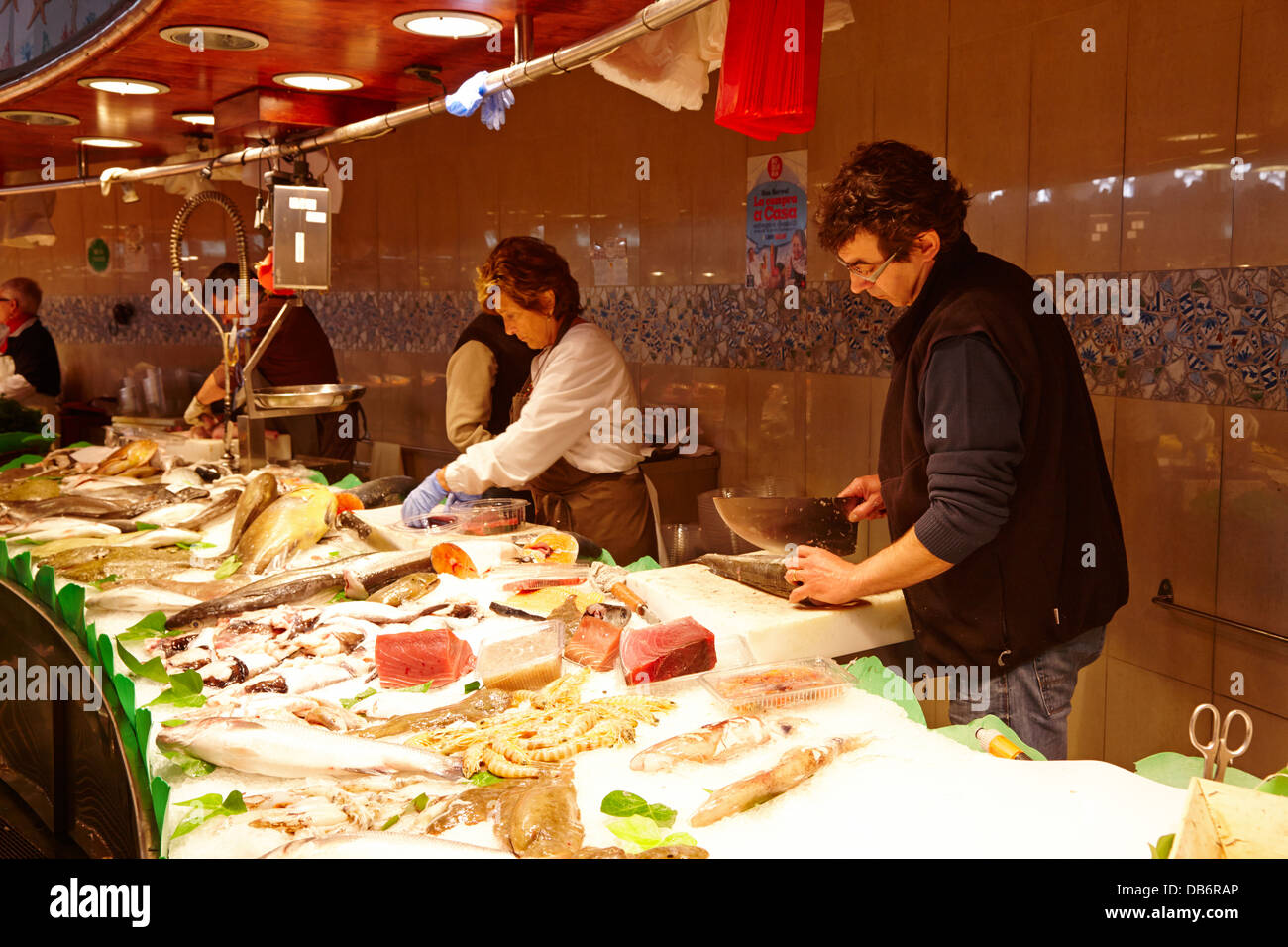 preparing fresh fish and seafood inside the la boqueria market in