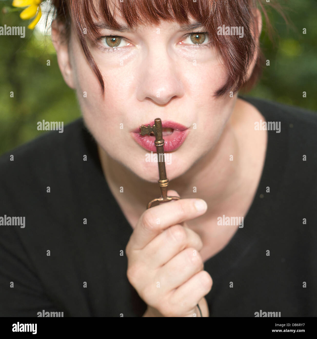 Young woman holding a skeleton key. Stock Photo