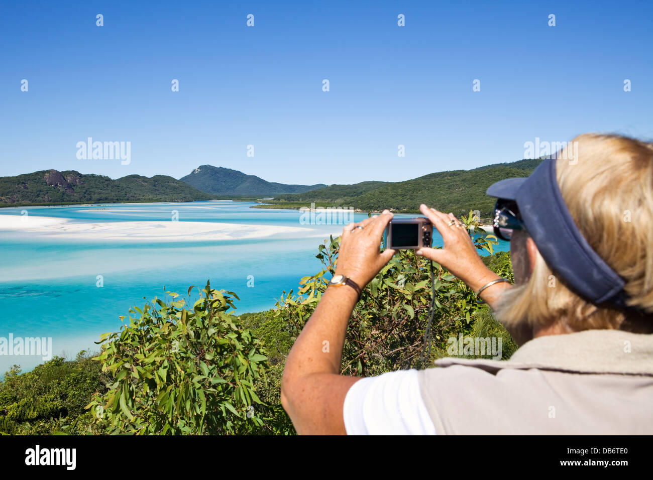 Tourist photographing scenic Hill Inlet. Whitsunday Island, Whitsundays, Queensland, Australia Stock Photo