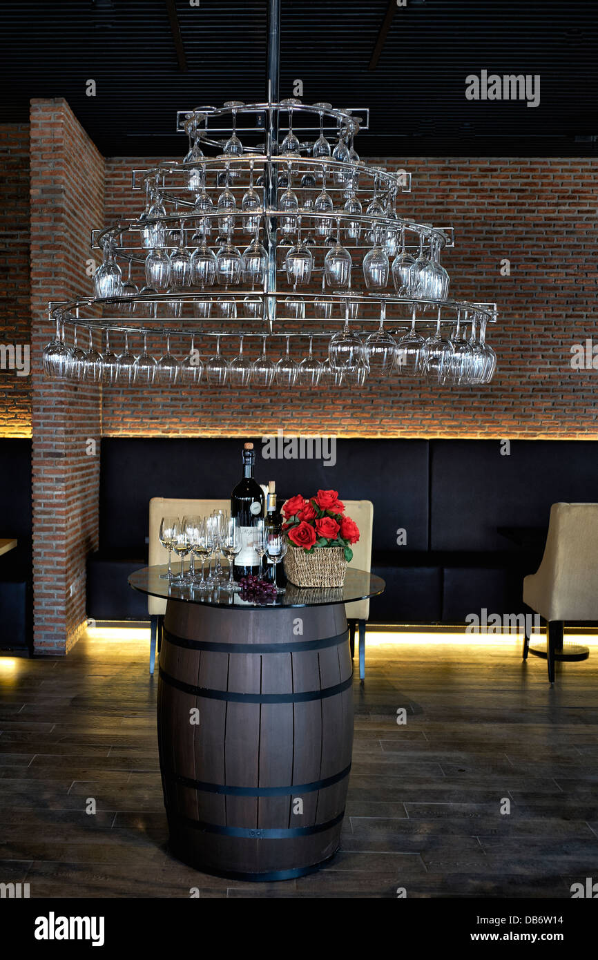 Wine bar interior advertising display featuring suspended wine glasses