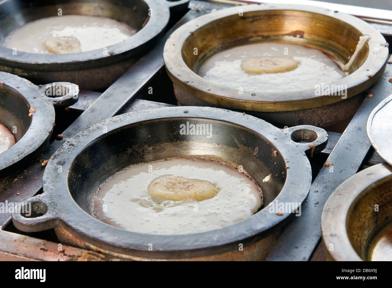 Making of Kueh Apom Balik Turnover Pancake with Banana in Brass Mold Pan at Local Food Hawker Stall in Penang Malaysia Stock Photo