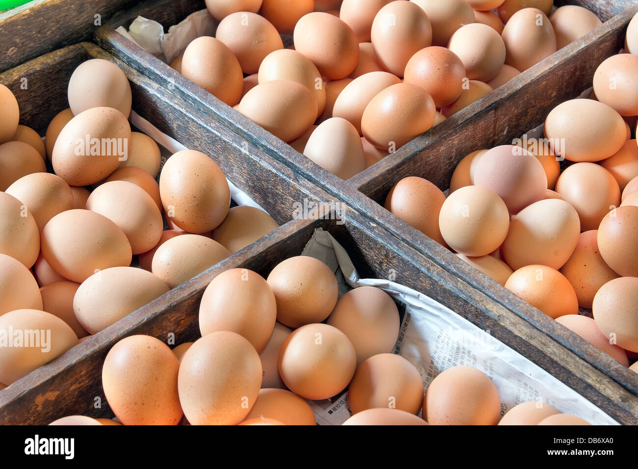 Chicken Egg Vendor with Eggs For Sale in Wooden Crates at Southeast Asia Wet Market Stock Photo