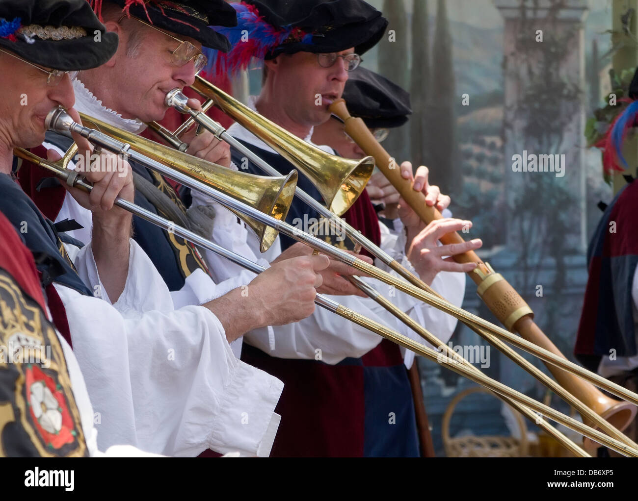 Musicians playing trombones dressed in period costumes Stock Photo Alamy