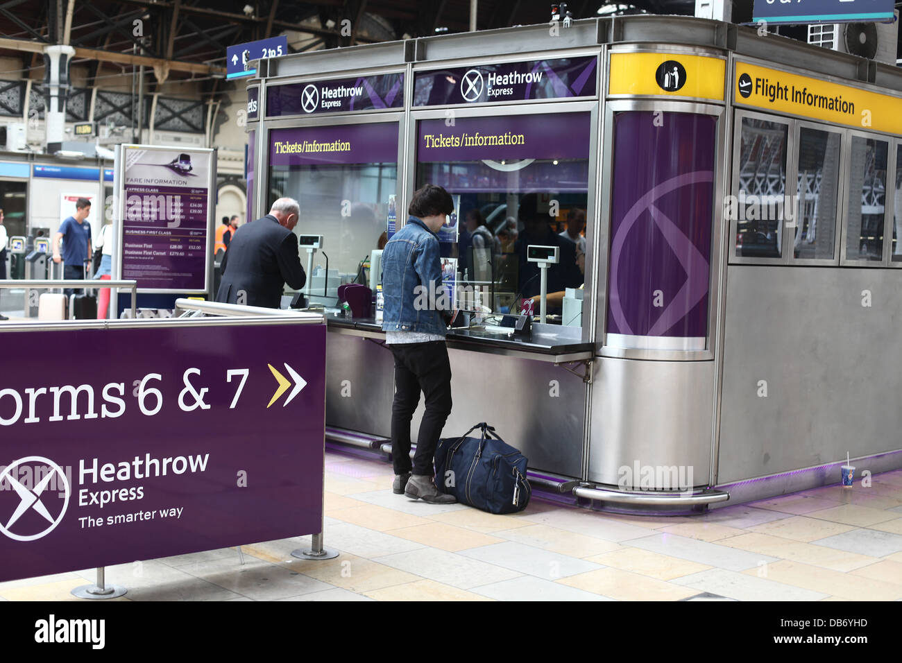 Two guys buying tickets for the Heathrow express from Paddington station,  July 2013 Stock Photo - Alamy
