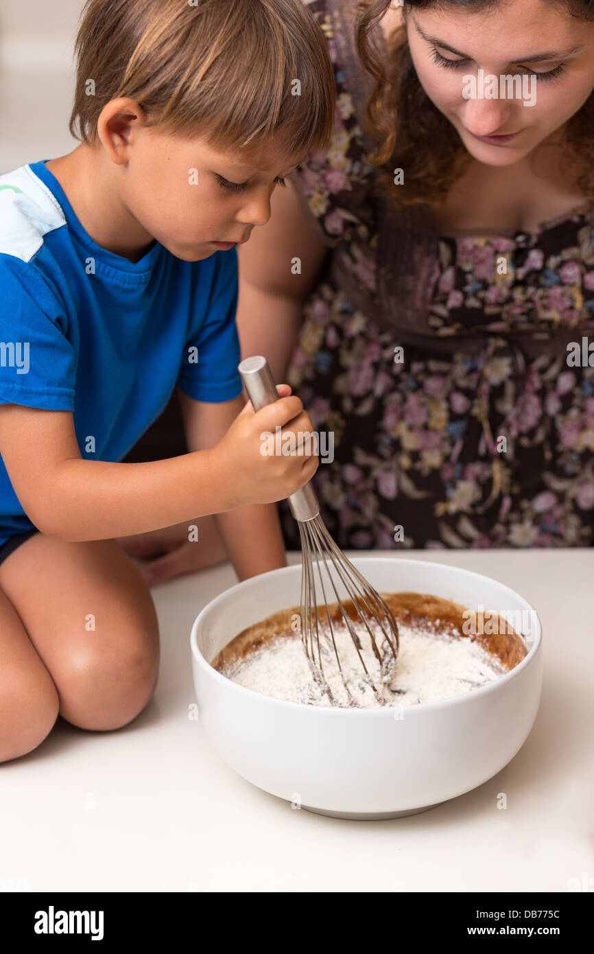 Little boy mixing chocolate pie dough Stock Photo Alamy