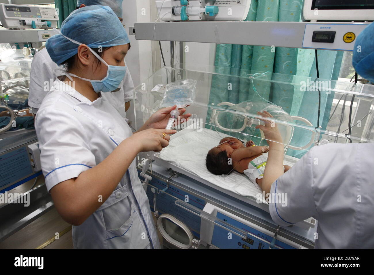 TWO HEADED BABY Conjoined female twins were born in Suining City on May 5, 2011. Two previous ultrasonic scans in September and February both revealled only a single embryo, but a final scan two days before the birth revealled that the daughter of mother Stock Photo