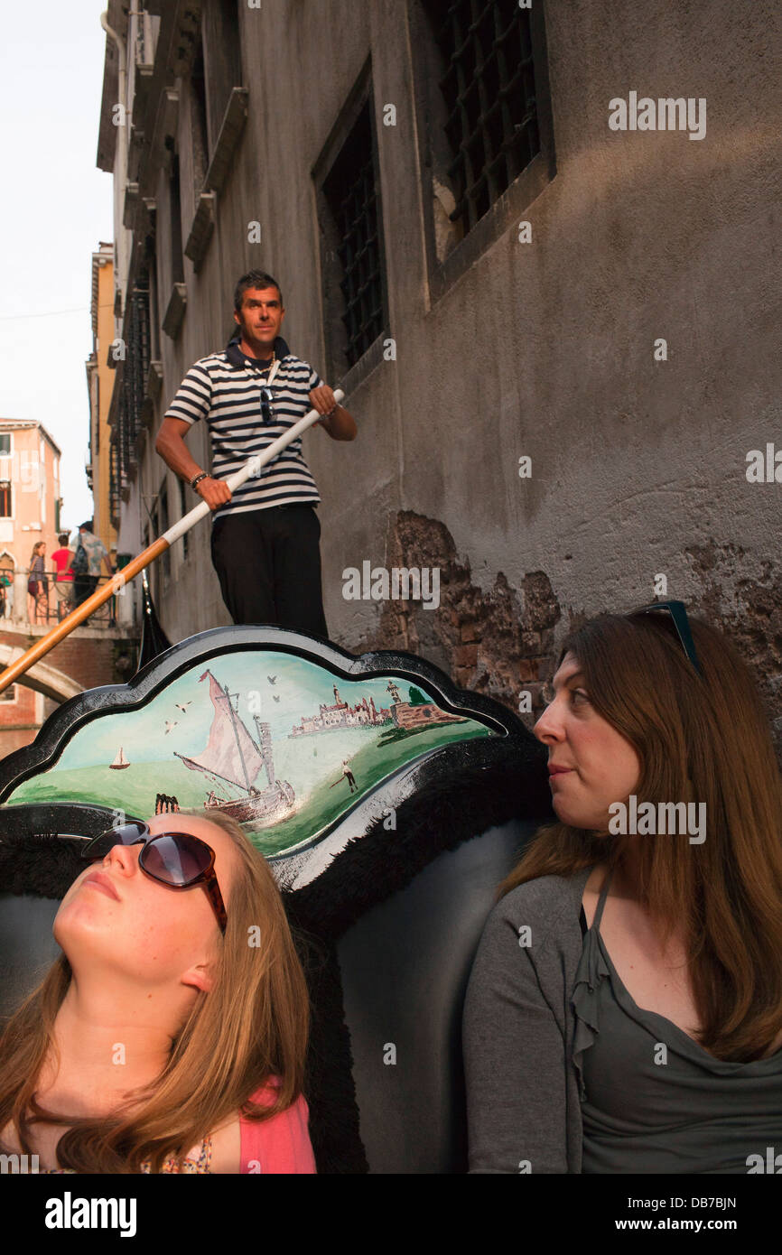 An auntie takes a gondola ride with her teenage niece on the canal in Venice, Italy. Stock Photo