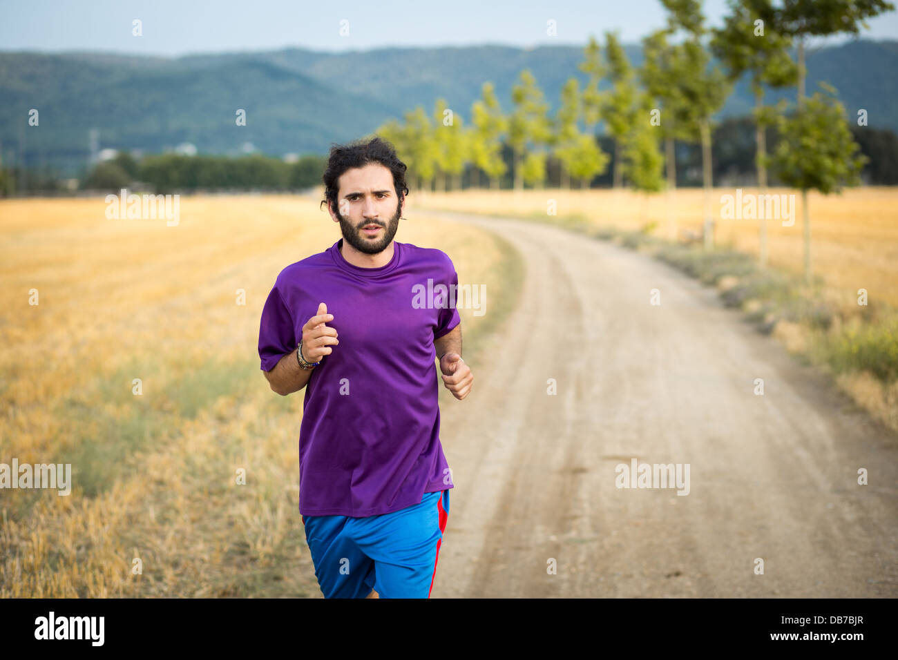 Young athletic man running in the nature Stock Photo