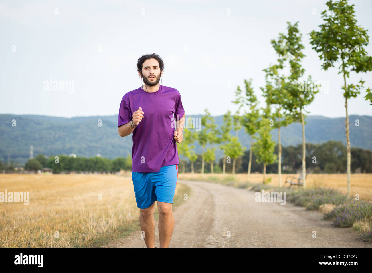 Young athletic man running in the nature Stock Photo