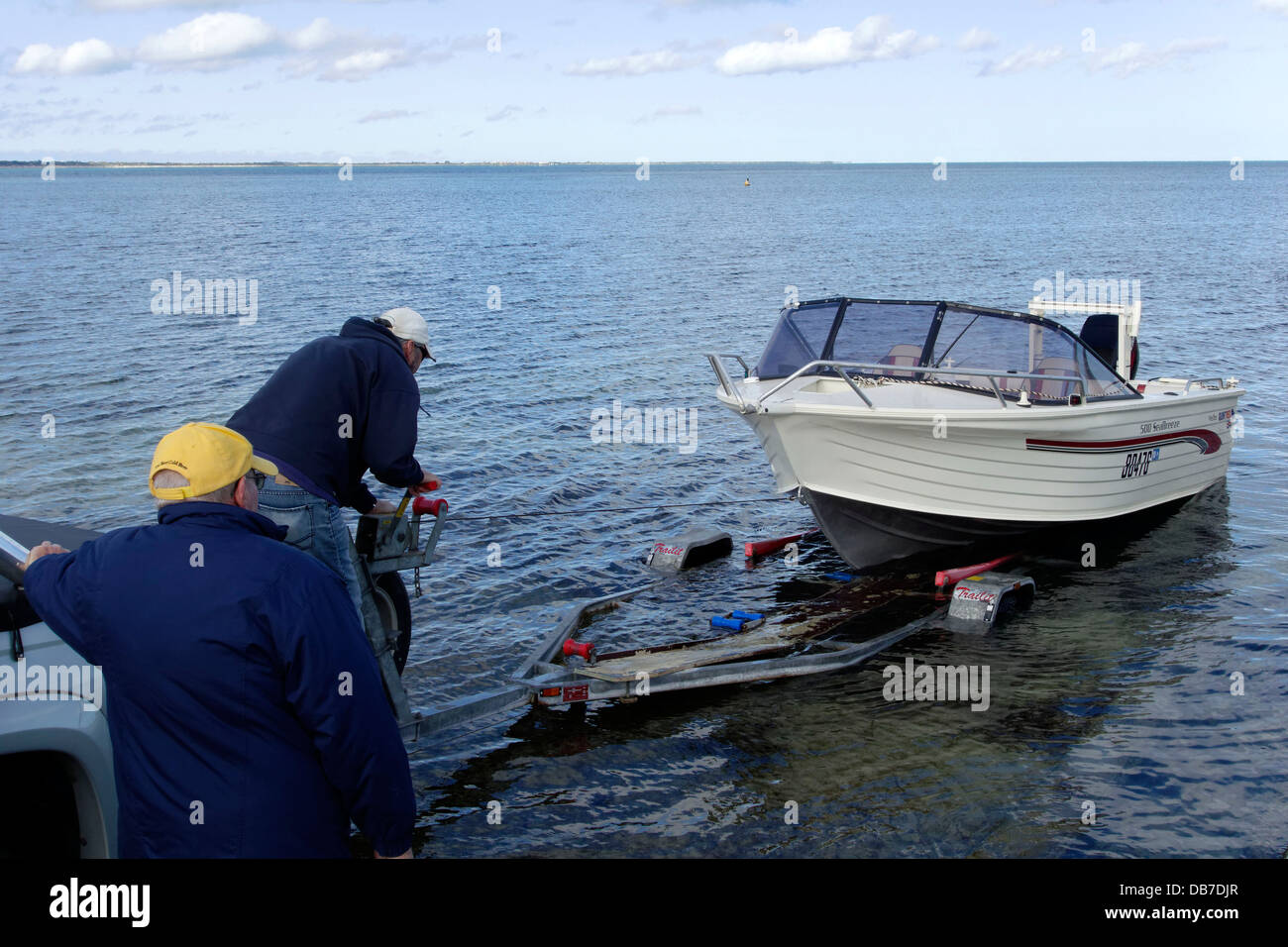 Small boat being winched onto a trailer, Western Australia Stock Photo