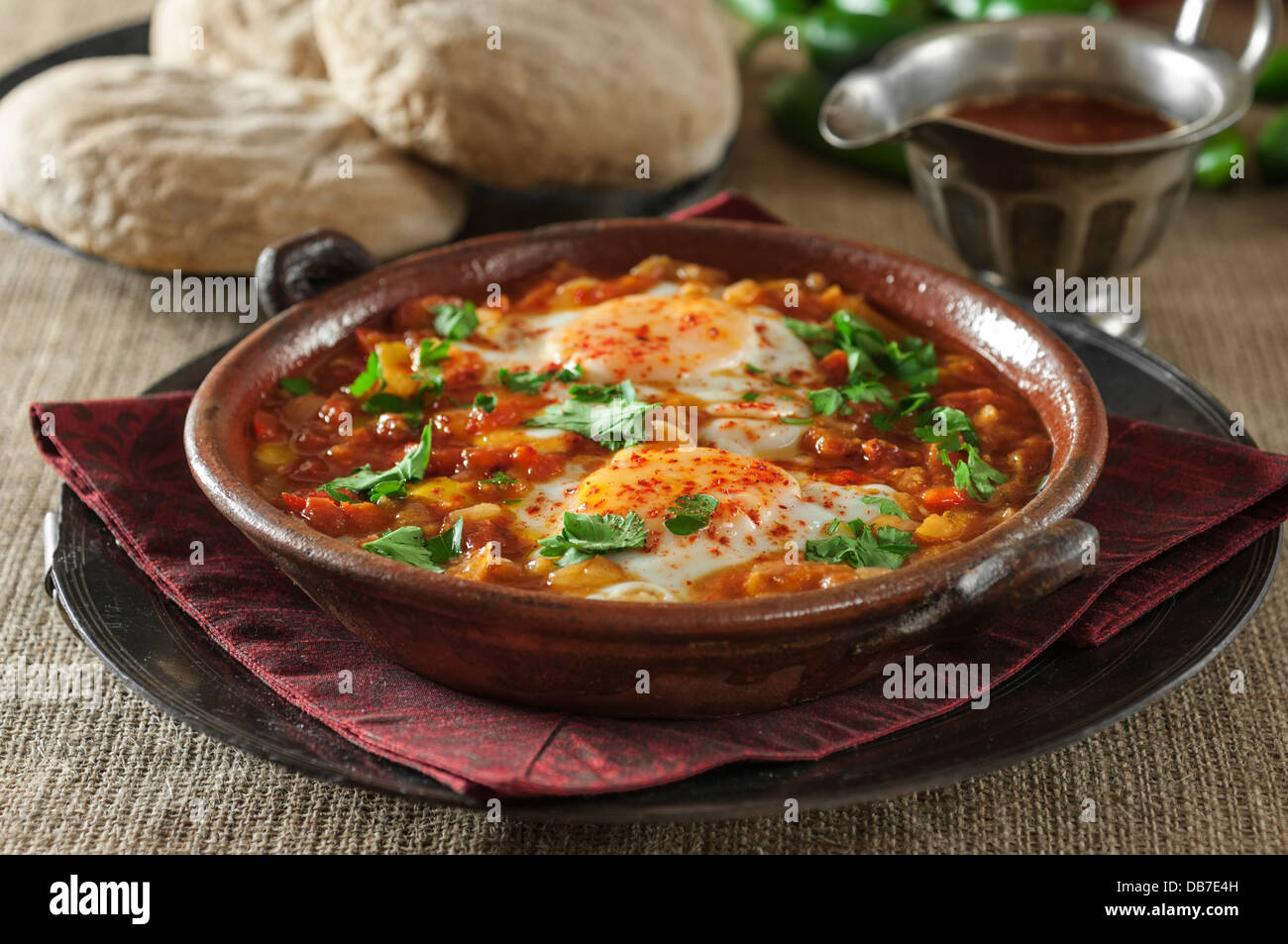 Shakshuka. Eggs in a spicy tomato and pepper sauce. Stock Photo