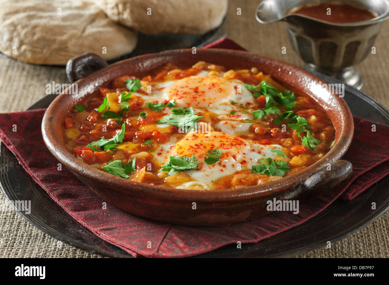 Shakshuka. Eggs in a spicy tomato and pepper sauce. Stock Photo