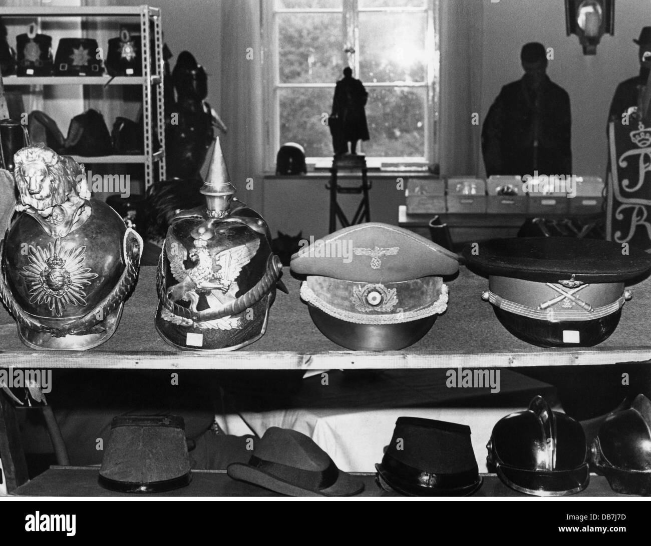 leisure time, hobbies, collecting, militaria, collection of different  headpieces, under it a peaked cap of Adolf Hitler, 1960s, Additional-Rights-Clearences-Not Available Stock Photo
