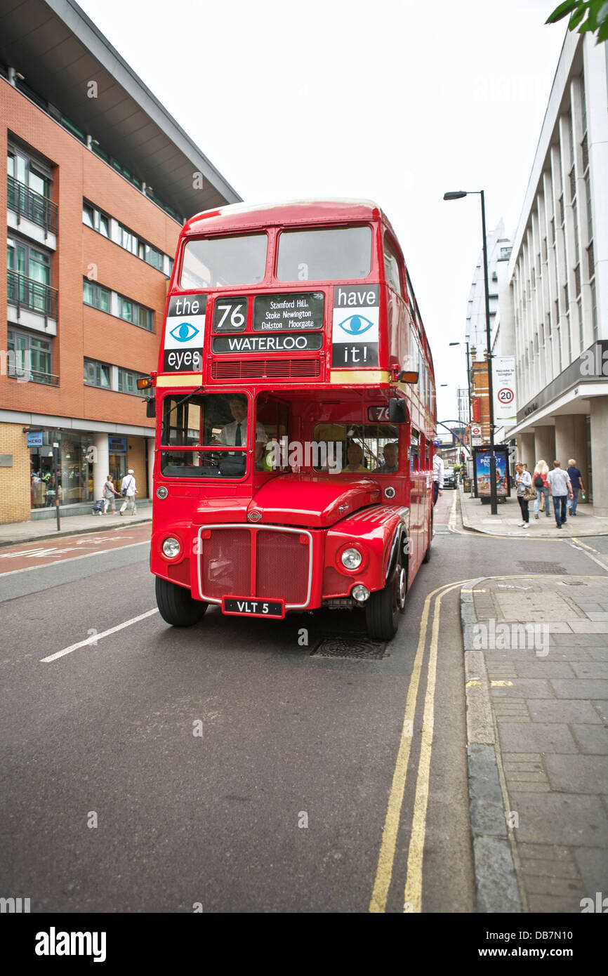 A red Routemaster London bus on a street in the City of London Stock Photo