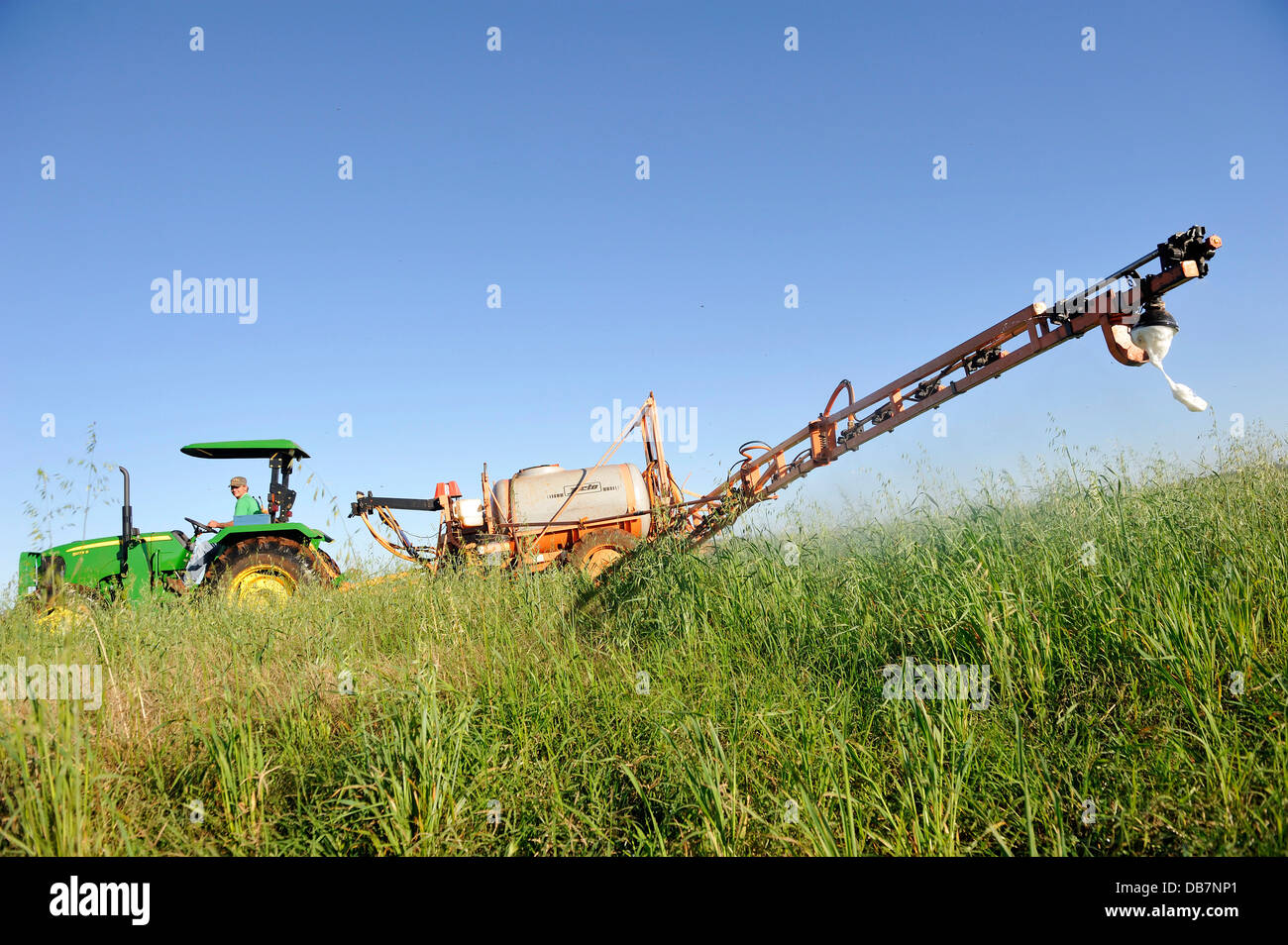 Spraying of pesticides on a field in a Mennonite community Stock Photo