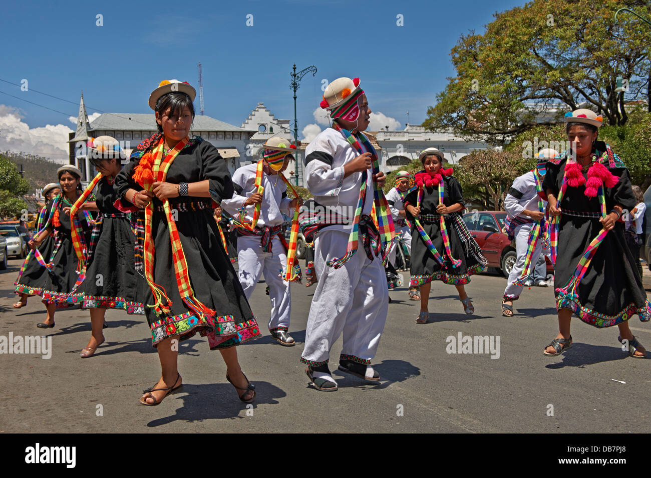 indigenous people with traditional costumes dancing in the street of Sucre, Bolivia, South America Stock Photo