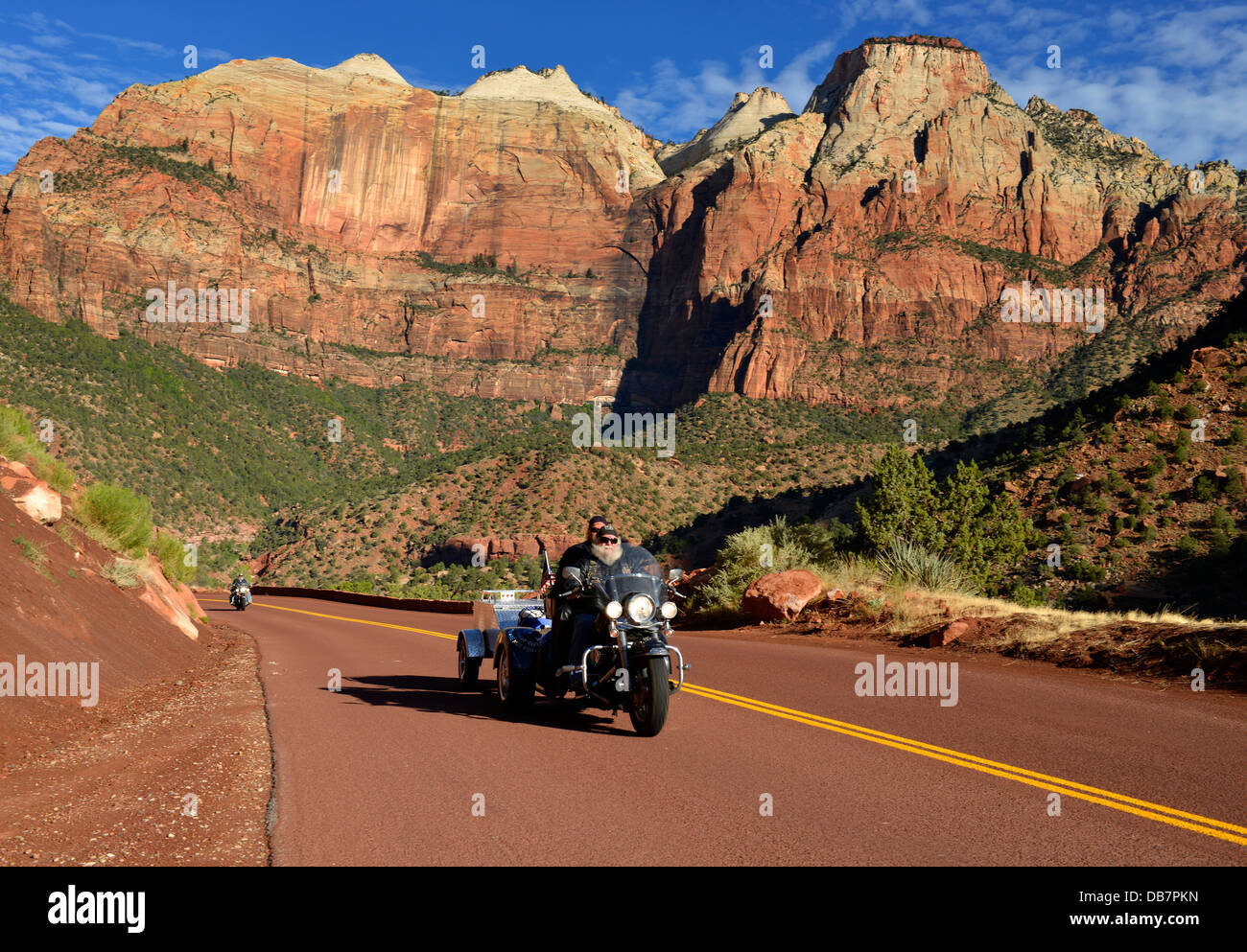 Harley Davidson motorcycle on the red road of Zion Park Boulevard - Mount Carmel U.S. Highway 9, in front of the Towers of the Stock Photo