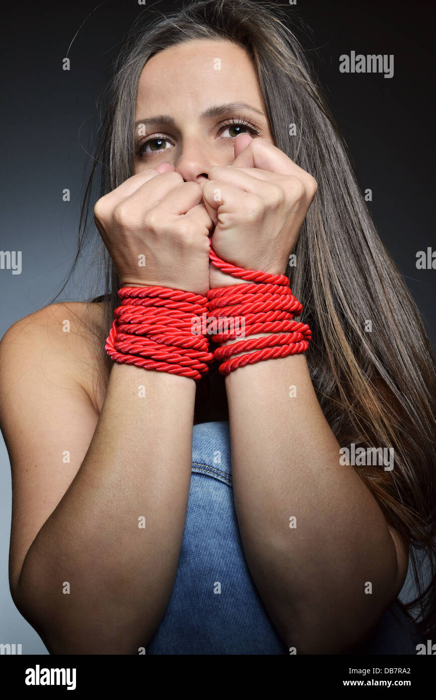 beautiful young woman tied with the red rope Stock Photo