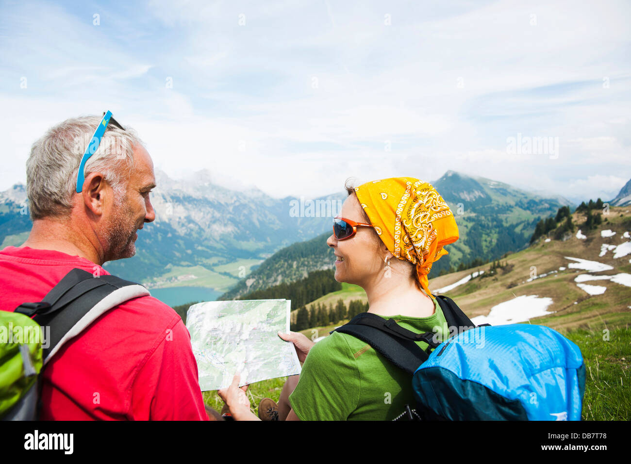 Hiking couple with map Stock Photo - Alamy