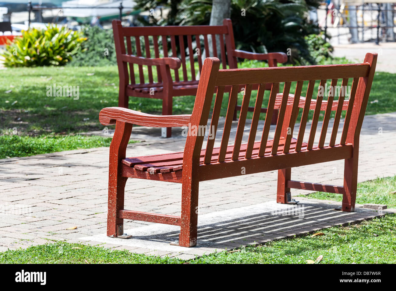 Two wooden benches sitting in the park. Stock Photo
