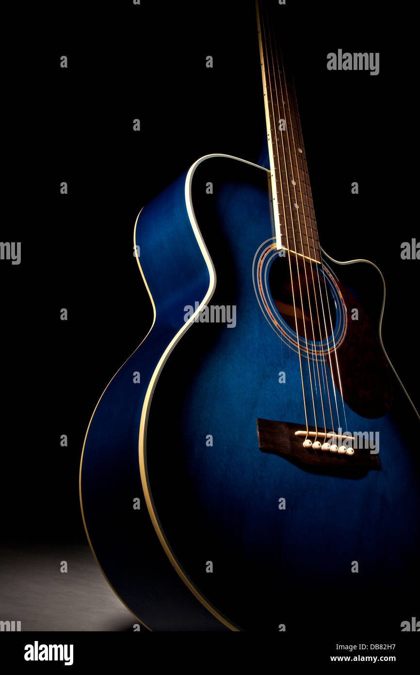 Guitar with blue finish on a mood dark background Stock Photo - Alamy