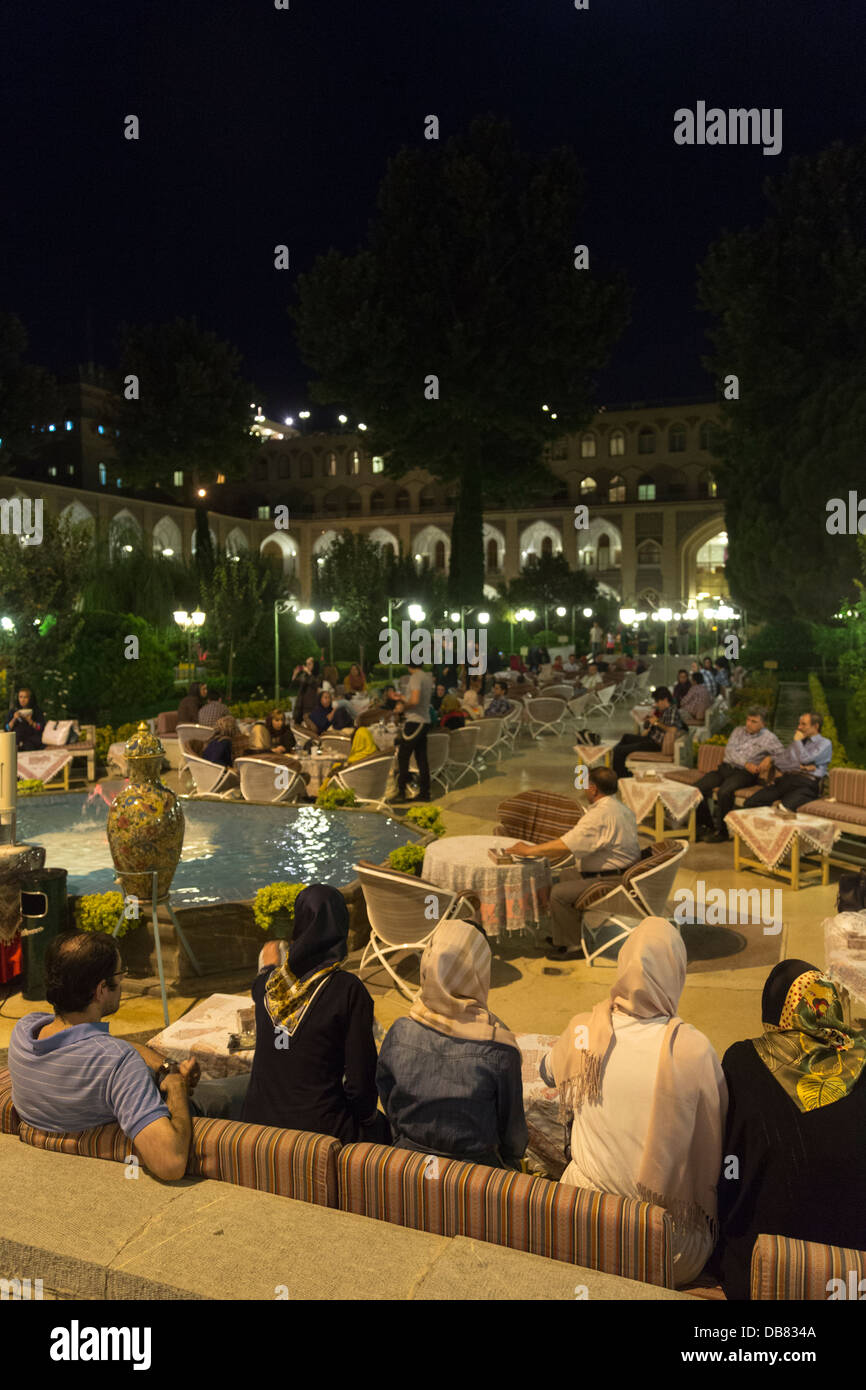 Iranians eating in the Abbasi Hotel, Isfahan, Iran, after breaking their fast during the fasting month of Ramadan Stock Photo