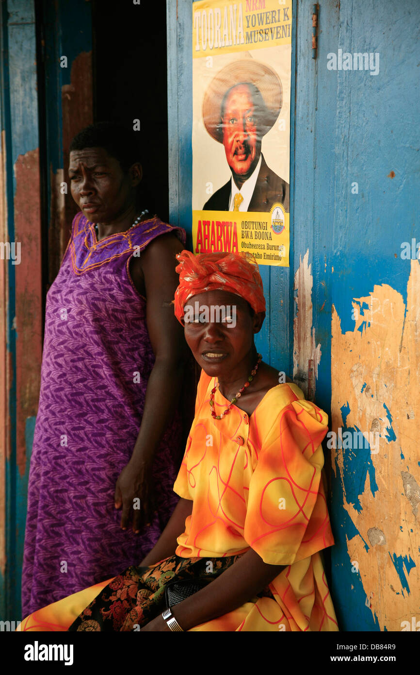 two African woman next to an election poster for President Yoweri Muyseveni of Uganda Stock Photo