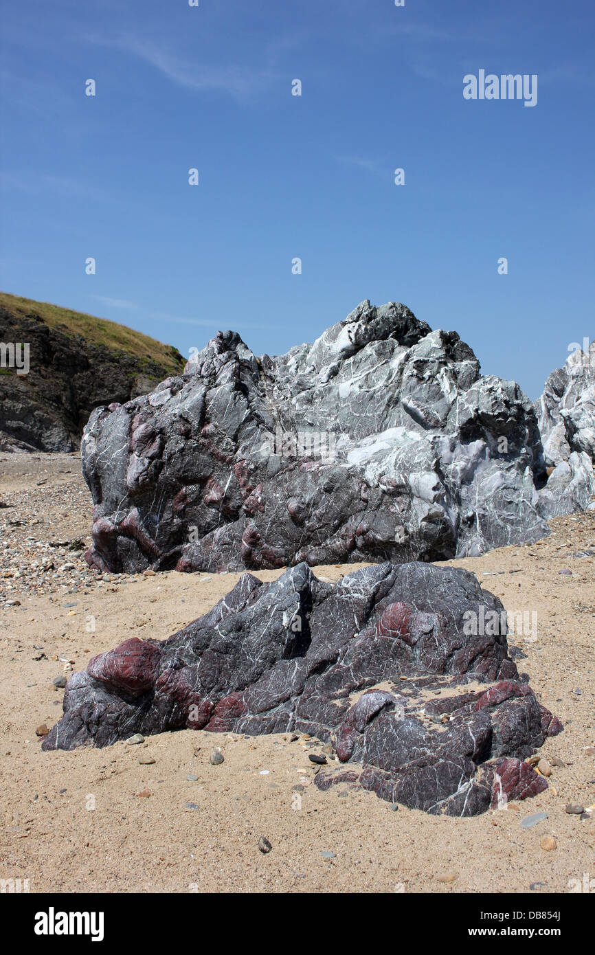 Grey and red (jasper) which are altered basaltic pillow lavas capped by Gwna limestone above Stock Photo