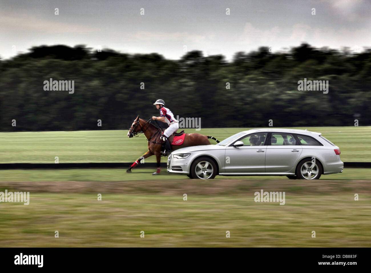 Polo Player Malcolm Borwick at the Guards Smith's Lawn Windsor Great Park riding at 38mph with Audi A6 the speed limit of the park, the maximum a horse can travel. Stock Photo