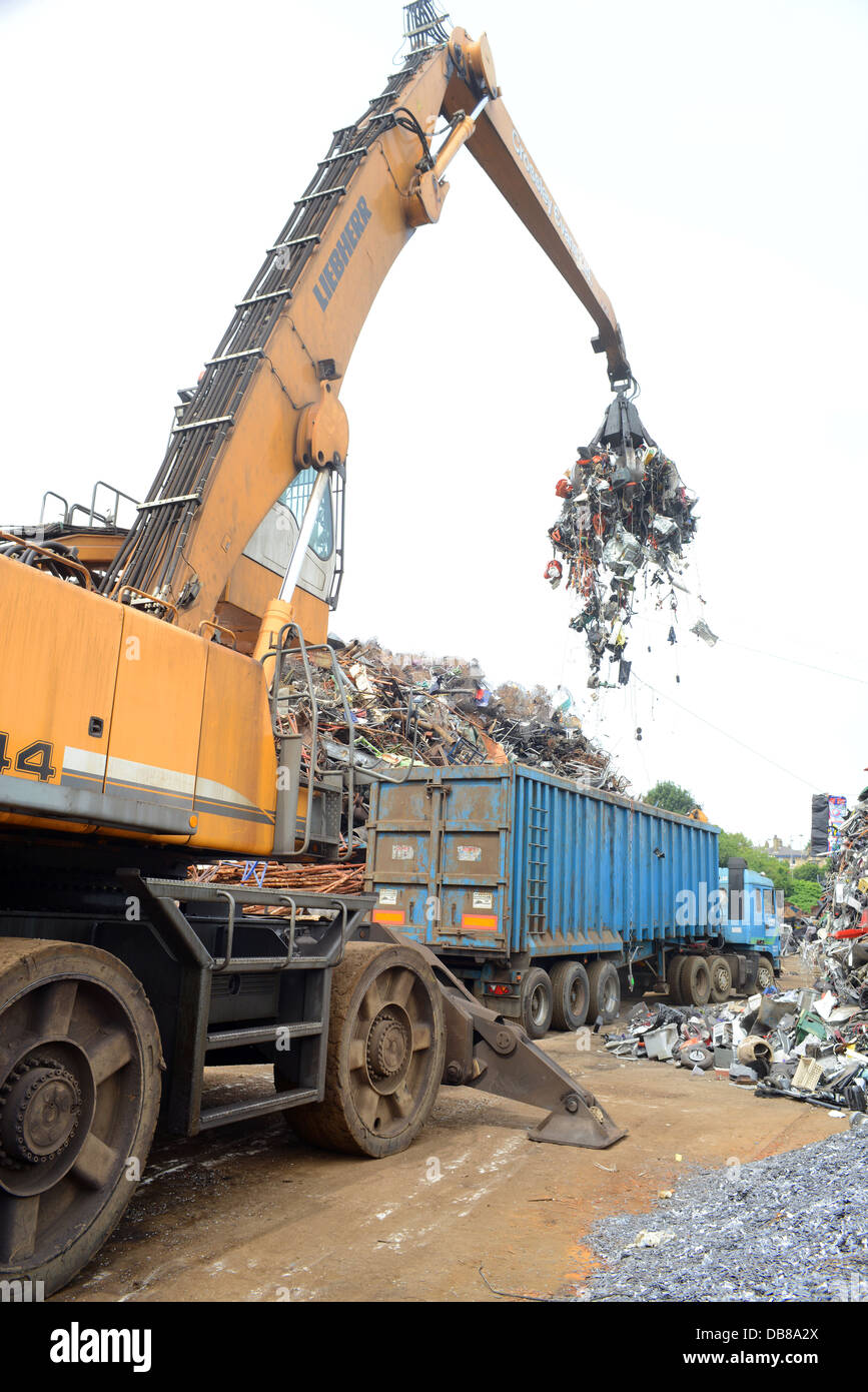 disposal of WEEE waste electronic and electrical equipment being loaded into wagon at processing