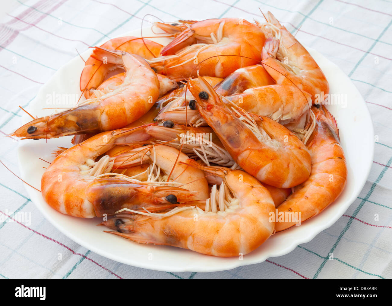 Pile of prepared shrimps lays on the plate Stock Photo