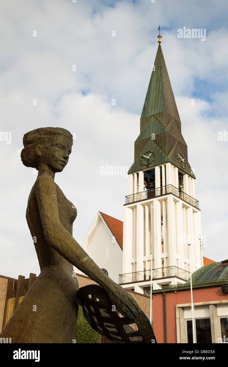 Statue of woman with Molde 'dom church' (domkjirke) in the background. In Molde, Norway Stock Photo