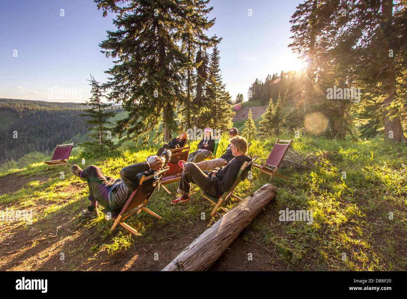 Group of people relaxing in chairs outdoors on vehicle supported mountain bike trip in South Western Colorado. Stock Photo
