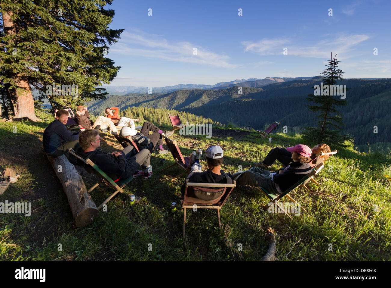 Group of people relaxing in chairs outdoors on vehicle supported mountain bike trip in South Western Colorado. Stock Photo