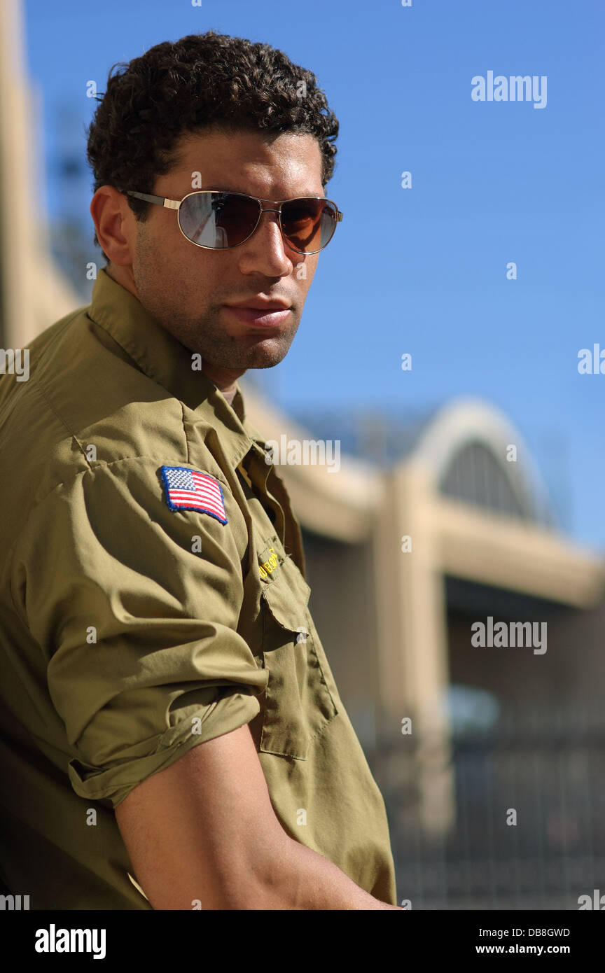 African American man male wearing a military shirt and sunglasses posing in  front of a downtown la bridge Stock Photo - Alamy
