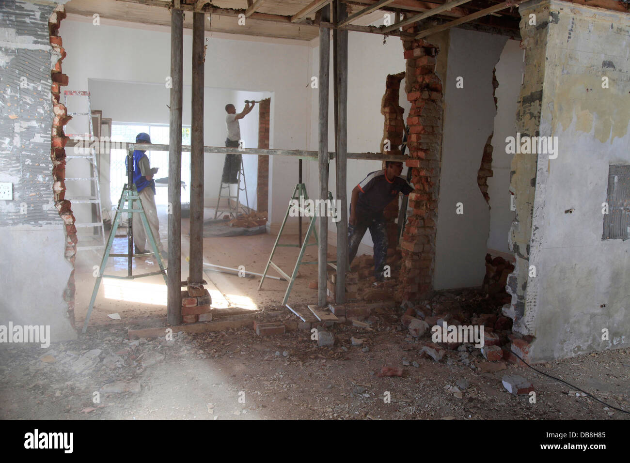 renovation on house, workers on site with walls knocked down Stock Photo
