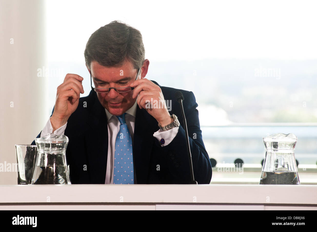 London, UK - 25 July 2013: Minister for Sport and Tourism, Rt Hon Hugh Robertson adjustes his eye glasses during the press conference Credit:  Piero Cruciatti/Alamy Live News Stock Photo