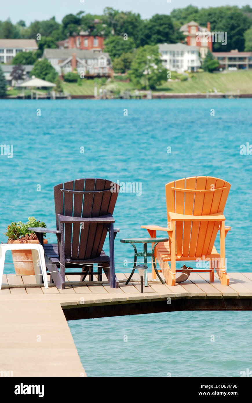 Brown And Orange Adirondack Chairs On A Dock Stock Photo 58583879