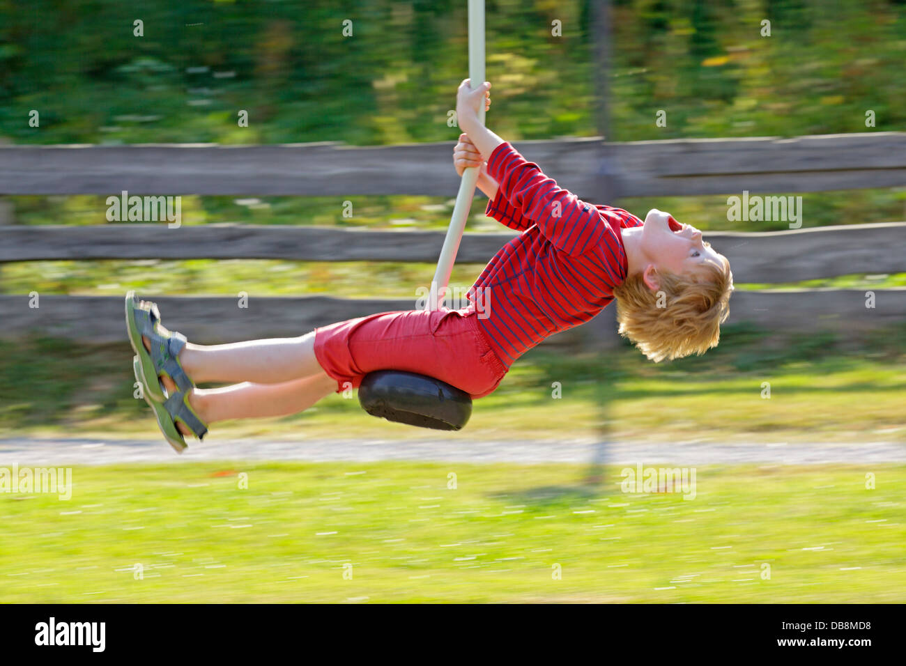 young boy riding playground ropeway Stock Photo