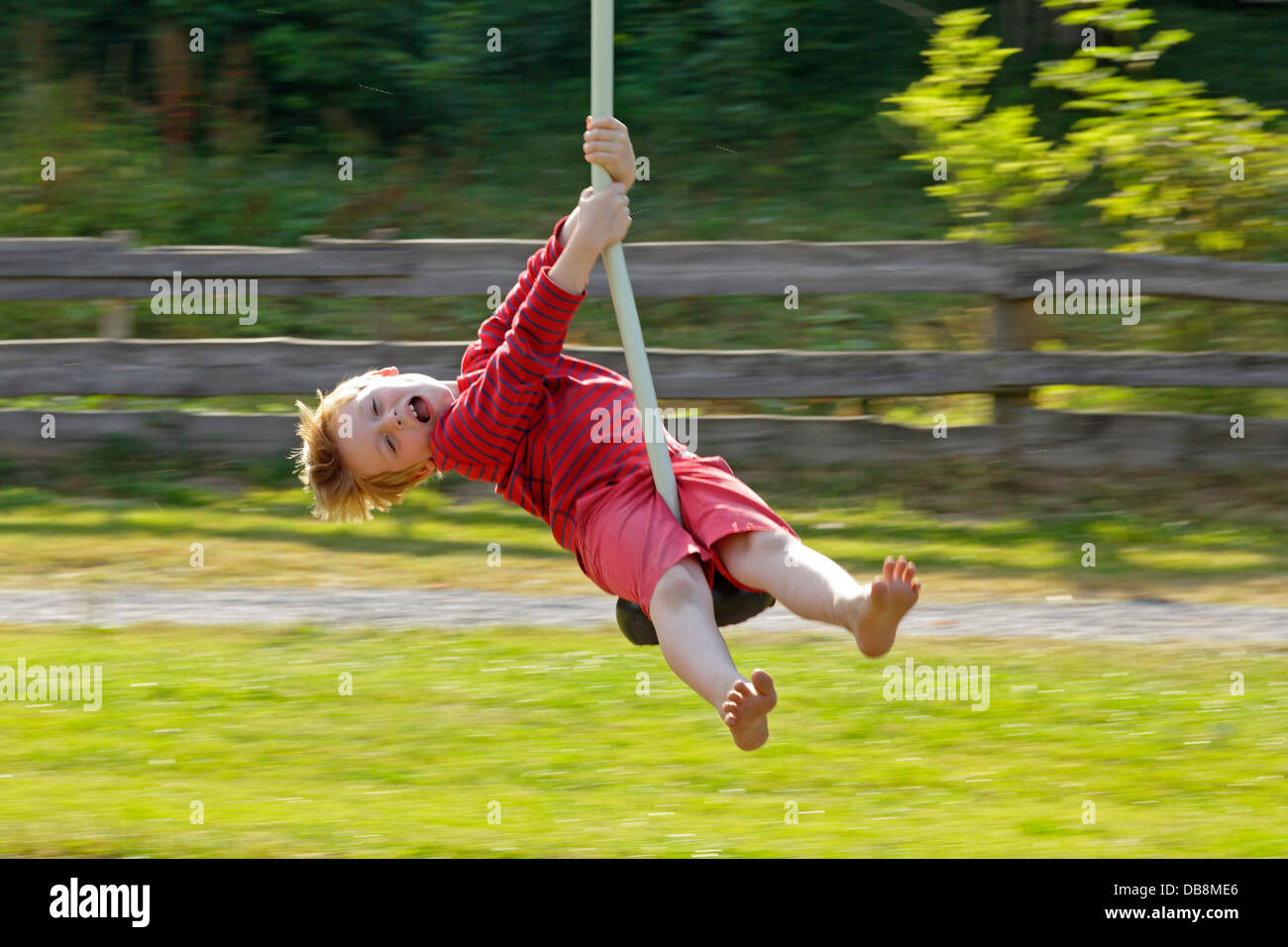 young boy riding playground ropeway Stock Photo