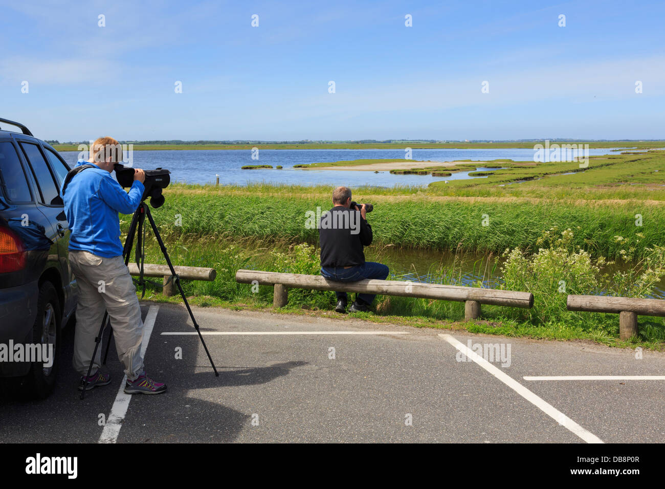 People using a telescope for birdwatching at Vejlerne Nature Centre overlooking  Lake Midtso in Bygholm Vejle in Jutland Denmark Stock Photo